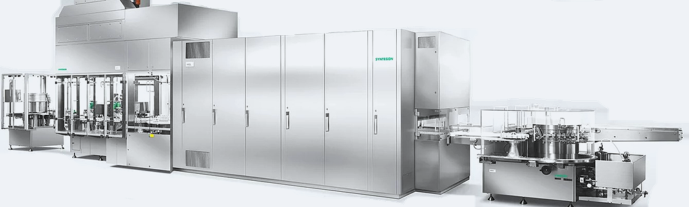 Continuous pharmaceutical processing line with washer, enclosed depyrogenation tunnel, conveyor, and downstream handling equipment