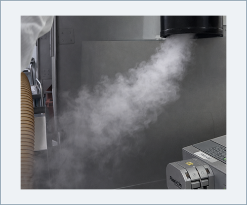 Smoke visualization demonstrating directed airflow protecting a defined local critical zone within a controlled enclosure.