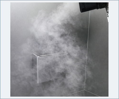 Smoke visualization showing lateral movement, swirling, and localized reflux around equipment within the airflow path.